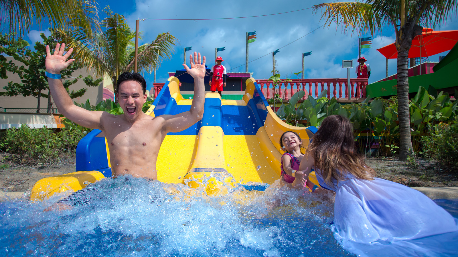 Family splashing on a water slide